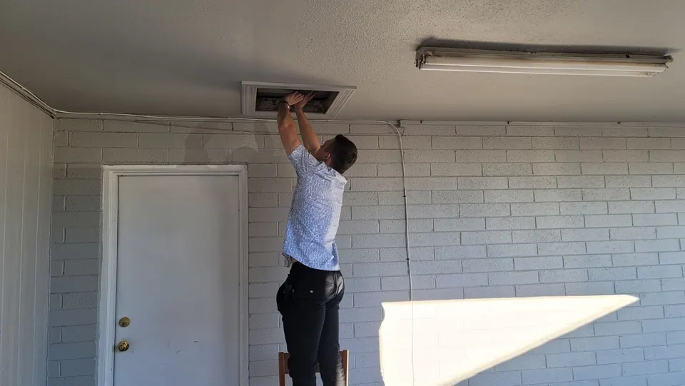 An RSDS appraiser checking the attic access during an inspection