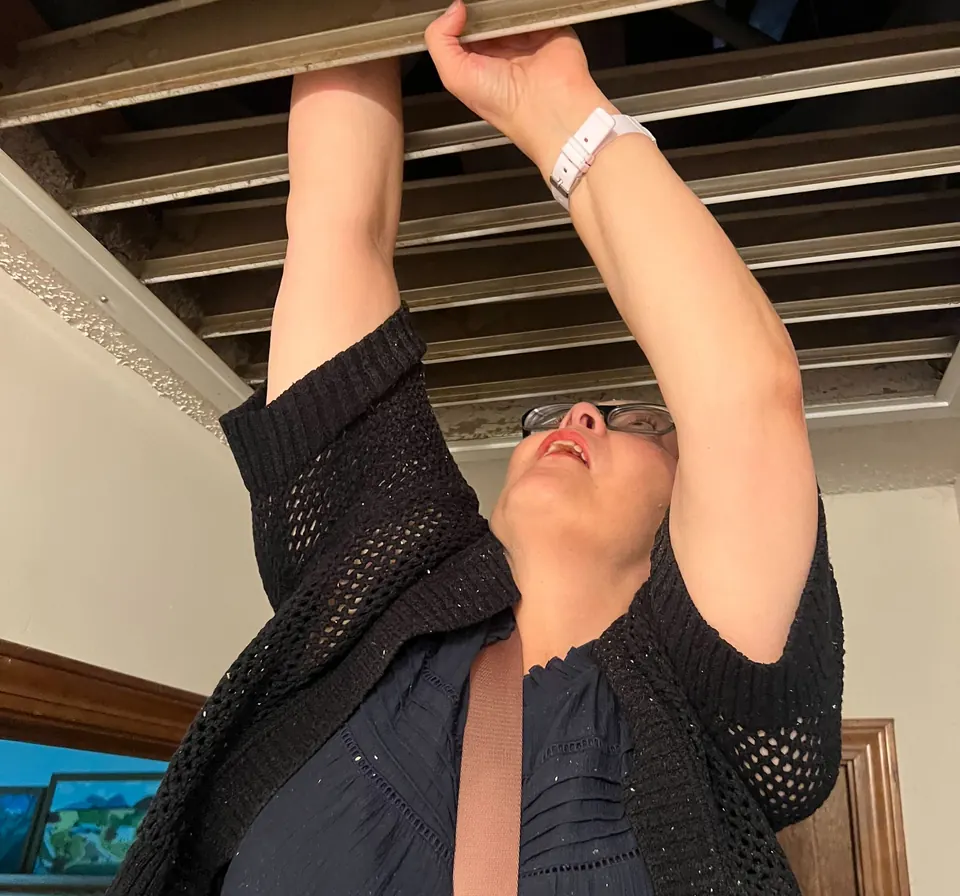 An RSDS staff appraiser checking a ceiling access panel during an inspection
