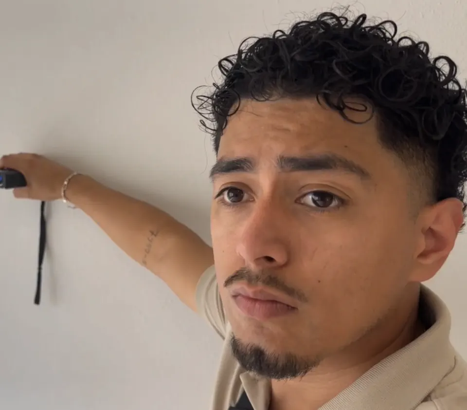 RSDS graduate Frank Flores measuring a room during an inspection